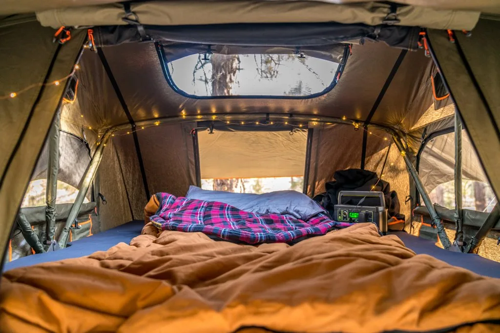 inside of overland roof tent, sleeping bag and lights